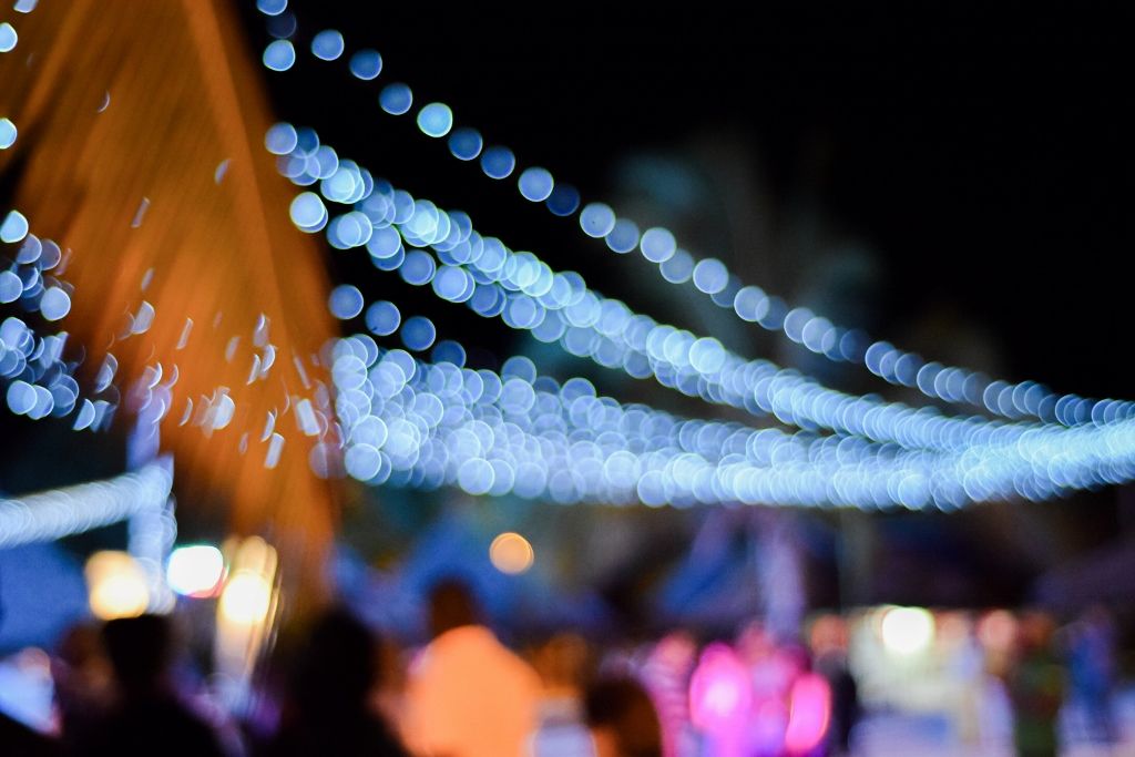 Festival night scene with strings of fairy lights and warm bokeh