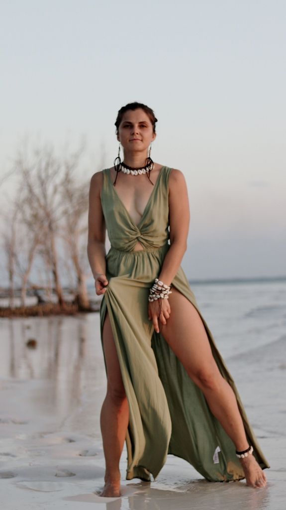 Beach portrait of a woman in a flowing olive green dress at sunset
