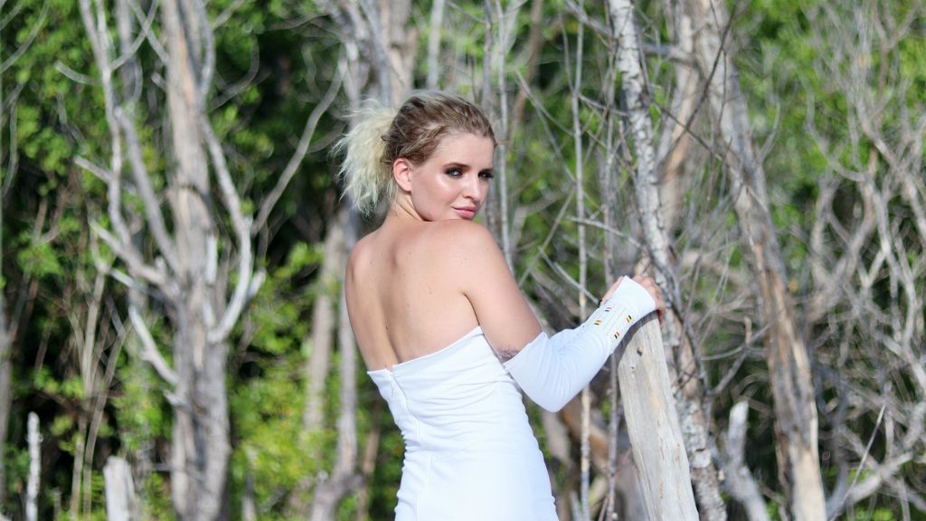 Mangrove portrait of a woman in a white dress turned away