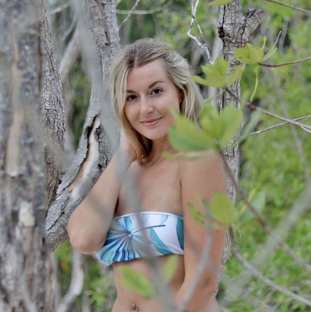 Mangrove portrait of a woman in a printed bandeau bikini between trees