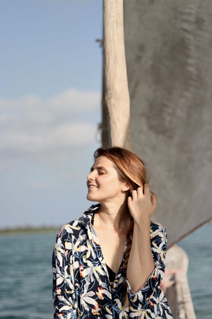 Travel portrait of a woman aboard a traditional dhow sailing boat