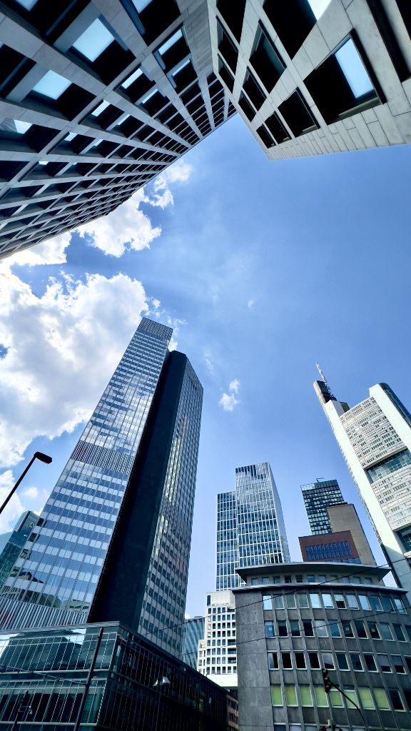 Wide-angle look up at Frankfurt skyscrapers under a blue sky