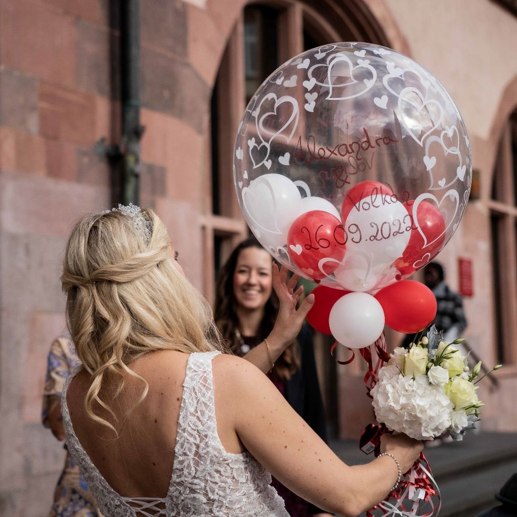 Wedding moment as the bride receives a personalised celebration balloon